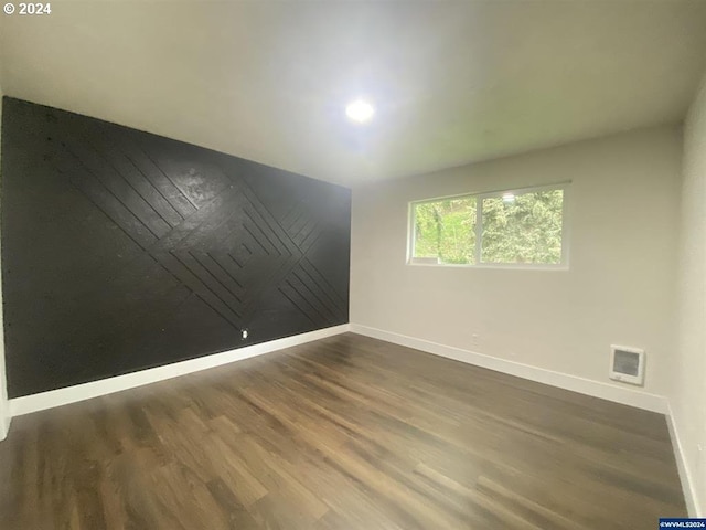 spare room with dark hardwood / wood-style flooring