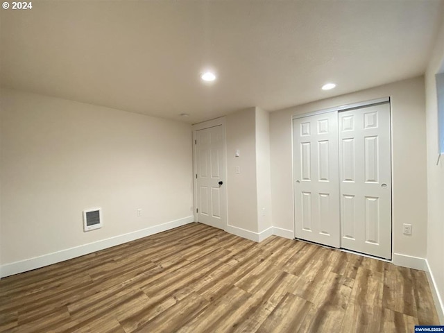 unfurnished bedroom featuring a closet and light hardwood / wood-style flooring