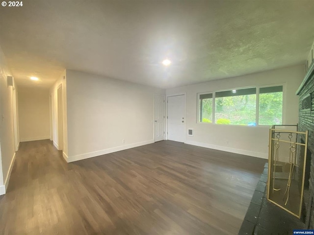 unfurnished living room featuring dark hardwood / wood-style floors