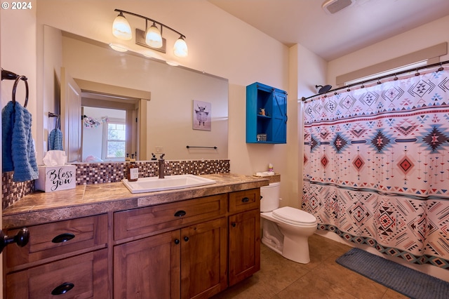 bathroom with vanity, a shower with curtain, toilet, and tile patterned flooring