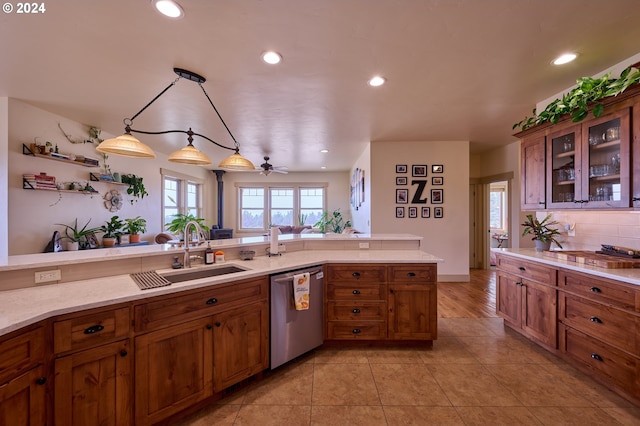 kitchen with sink, light tile patterned flooring, pendant lighting, stainless steel dishwasher, and ceiling fan