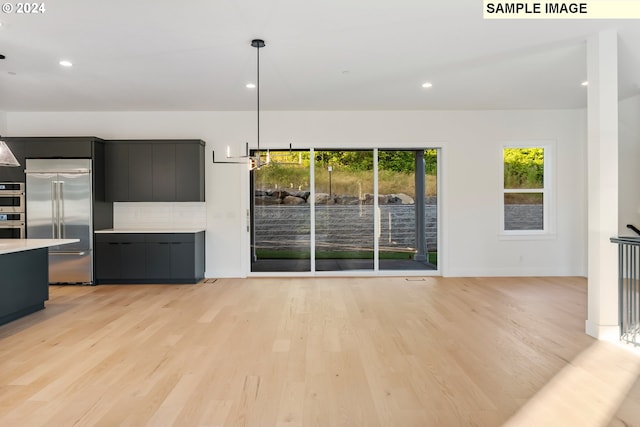 unfurnished living room with light wood-style flooring, baseboards, and recessed lighting