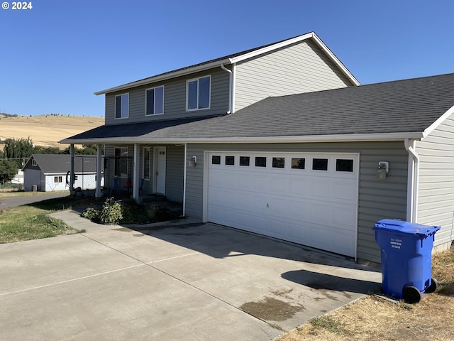 view of front of home featuring covered porch and a garage