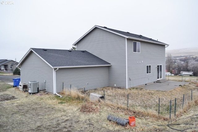 view of side of property with central air condition unit