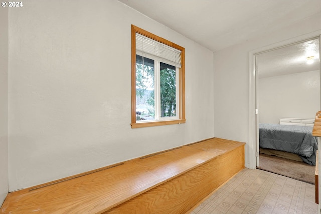 corridor featuring light colored carpet