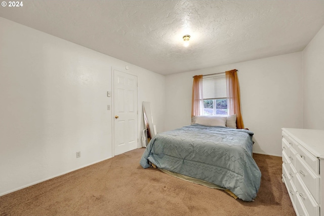 carpeted bedroom with a textured ceiling