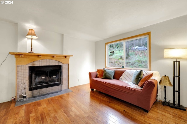 living room featuring hardwood / wood-style floors and a tile fireplace