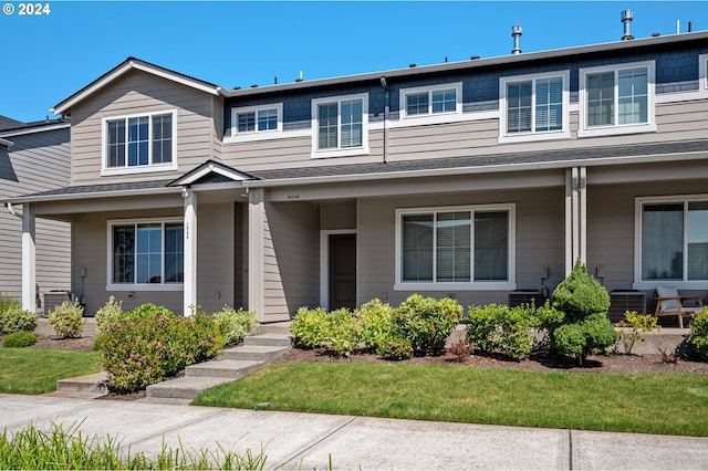 view of front of house featuring a front yard and central AC