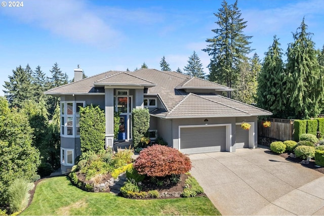 view of front of home with a garage and a front lawn