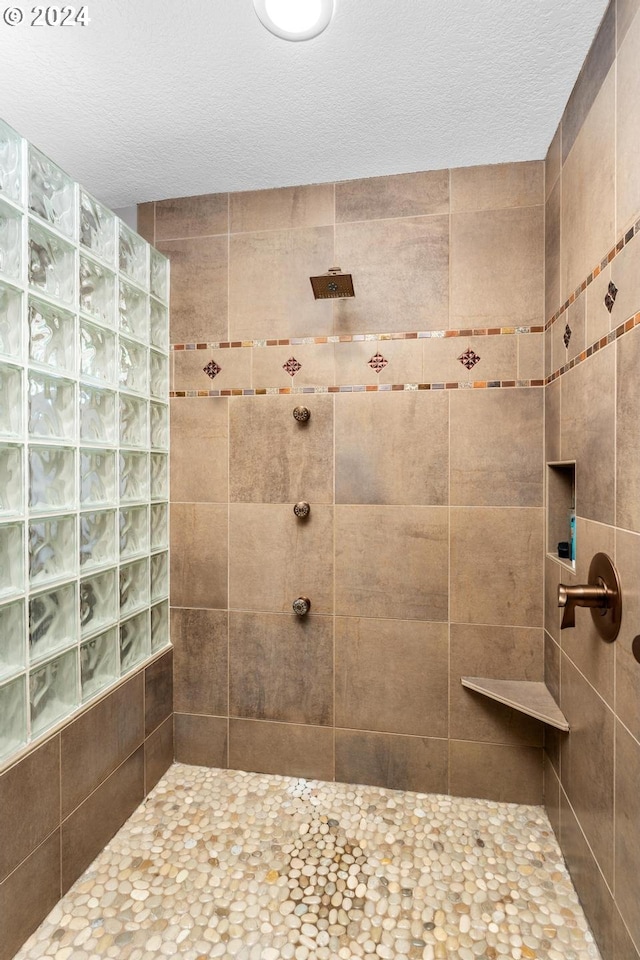 full bath featuring walk in shower and a textured ceiling