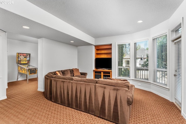 carpeted living area with baseboards, a textured ceiling, and recessed lighting