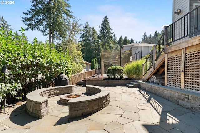 view of patio / terrace featuring stairs, an outdoor fire pit, and fence