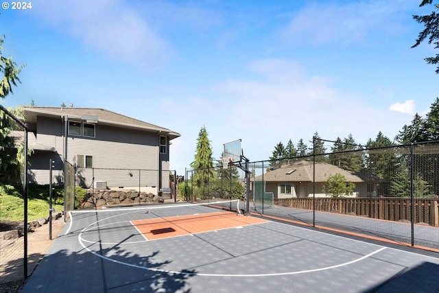 view of sport court with a tennis court, community basketball court, and fence