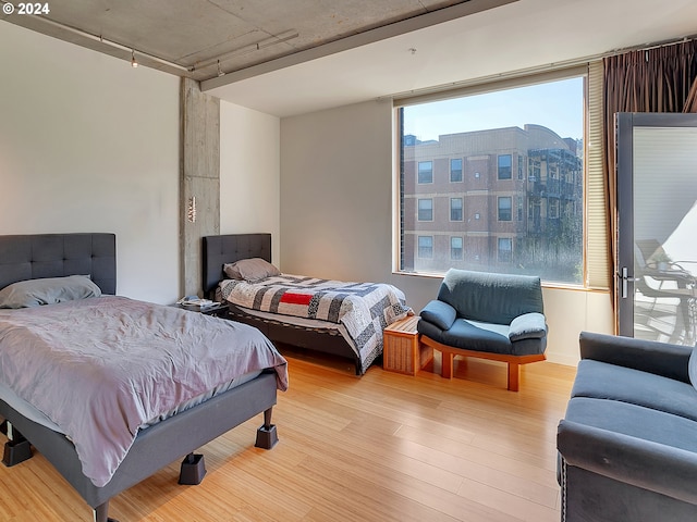 bedroom featuring light wood-type flooring and multiple windows