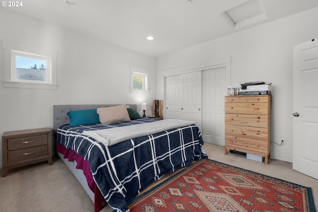 bedroom featuring a closet, carpet flooring, and multiple windows