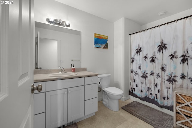 bathroom featuring vanity, curtained shower, and toilet