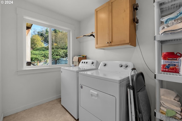 laundry area with cabinets and washer and clothes dryer