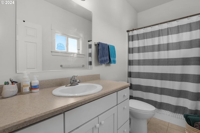 bathroom with vanity, toilet, tile patterned floors, and curtained shower