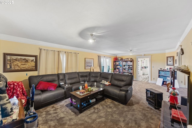 living room with carpet floors, crown molding, and ceiling fan