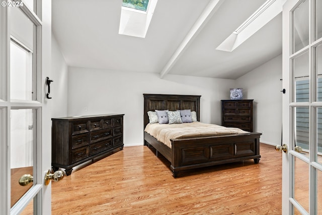 empty room with a wealth of natural light, lofted ceiling, and light wood-type flooring