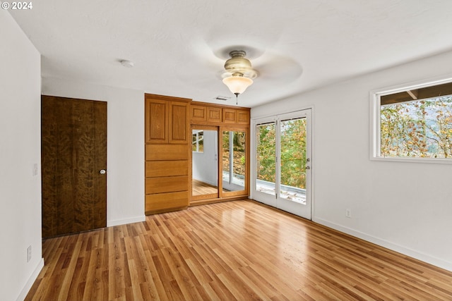 living room with ornamental molding, a textured ceiling, and light wood-type flooring