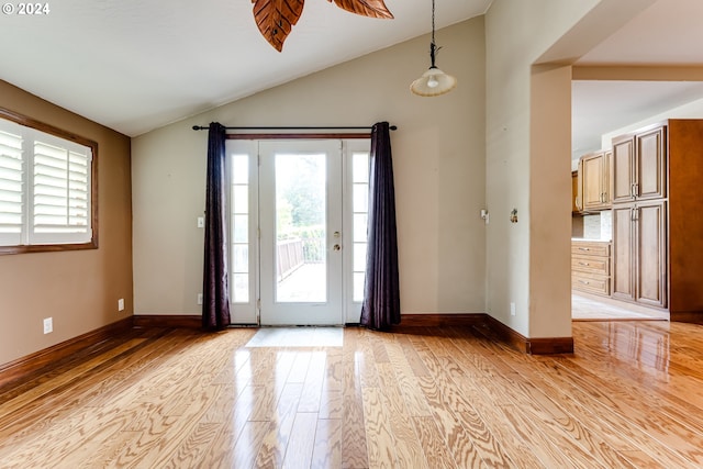 foyer featuring high vaulted ceiling and light wood-type flooring