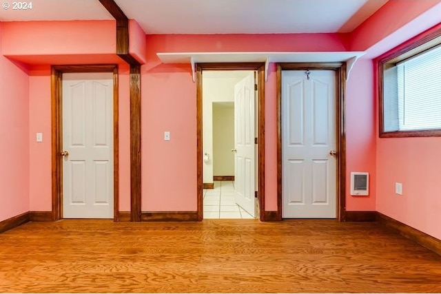 interior space with heating unit and light hardwood / wood-style floors