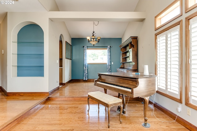 misc room featuring an inviting chandelier and light wood-type flooring