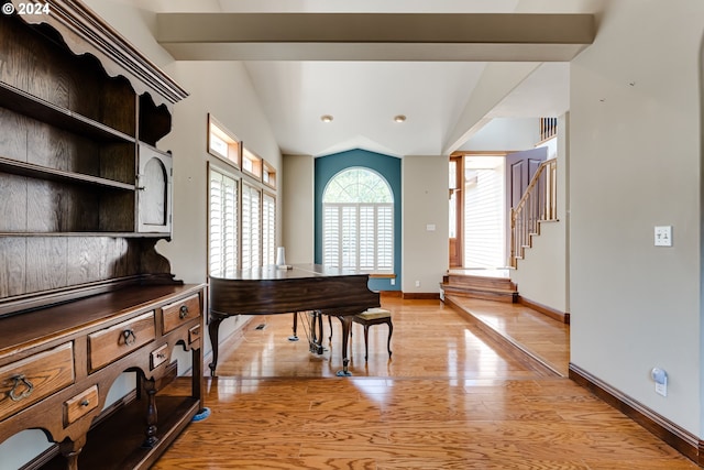 misc room with lofted ceiling and light hardwood / wood-style floors