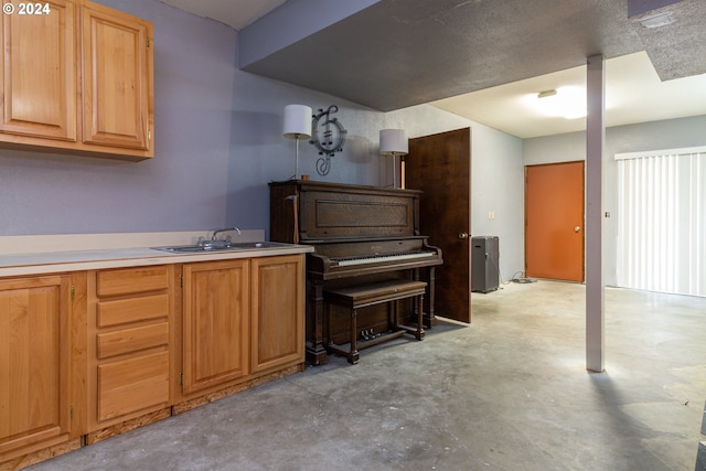 misc room with a textured ceiling and sink