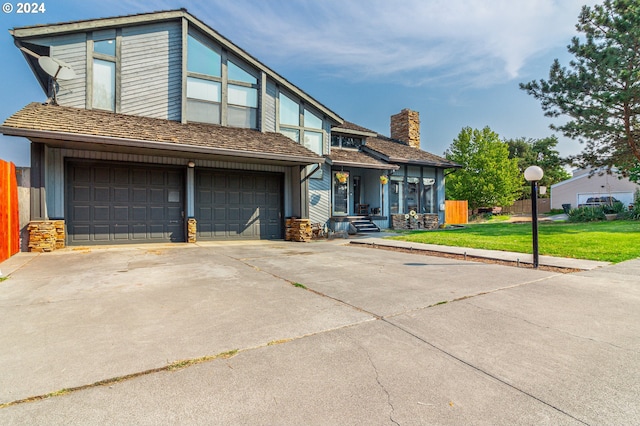 view of front of property with a front lawn and a garage