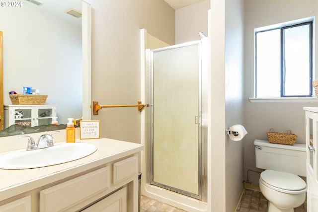 bathroom with vanity, walk in shower, and toilet