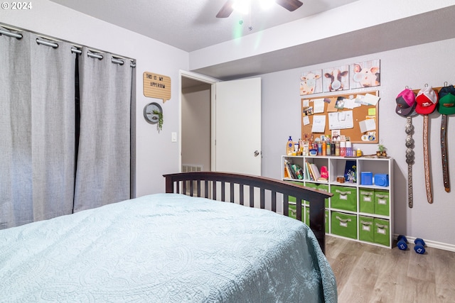 bedroom featuring light hardwood / wood-style flooring and ceiling fan