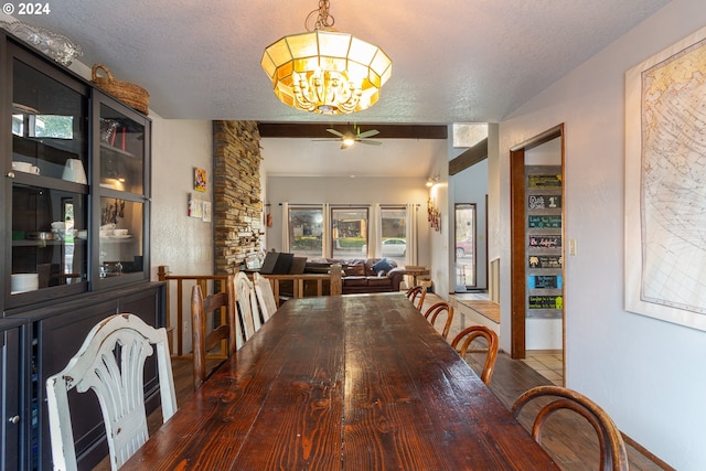 dining room with a textured ceiling, ceiling fan with notable chandelier, and hardwood / wood-style floors