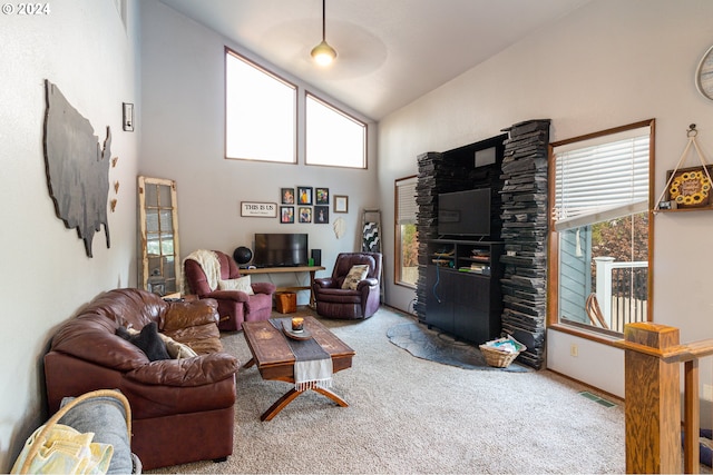 living room with high vaulted ceiling, carpet, and a wealth of natural light