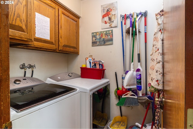 clothes washing area featuring independent washer and dryer and cabinets