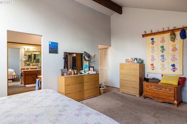 bedroom featuring ensuite bath, lofted ceiling with beams, and light colored carpet