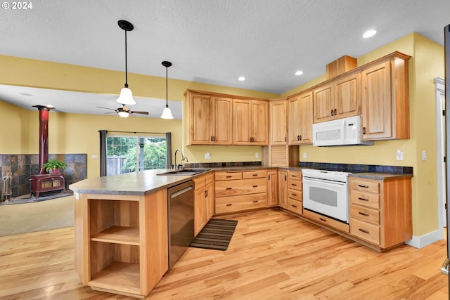 kitchen featuring sink, light brown cabinets, pendant lighting, white appliances, and light hardwood / wood-style floors