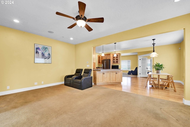 living room with light carpet, ceiling fan, and french doors