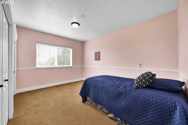 carpeted bedroom featuring a textured ceiling