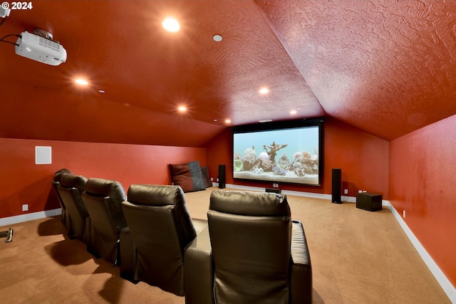 cinema room with light colored carpet, vaulted ceiling, and a textured ceiling