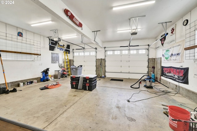 garage featuring a garage door opener and electric panel