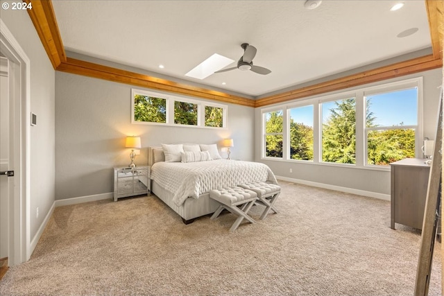 carpeted bedroom featuring ceiling fan and a skylight