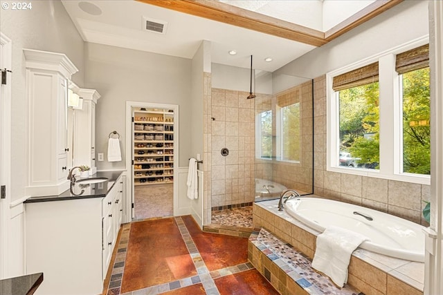 bathroom with independent shower and bath and vanity