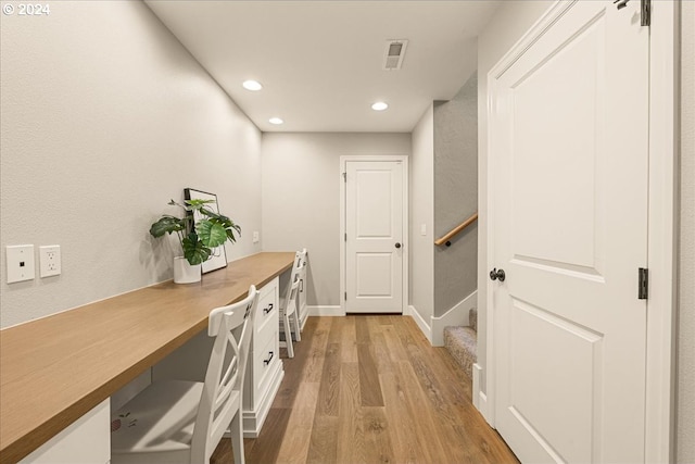 office area featuring light hardwood / wood-style flooring and built in desk