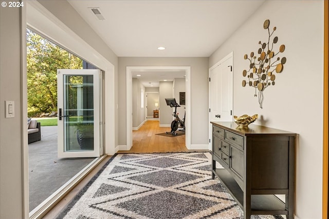 doorway to outside featuring light hardwood / wood-style floors and french doors