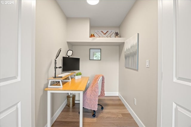 office area with light hardwood / wood-style floors