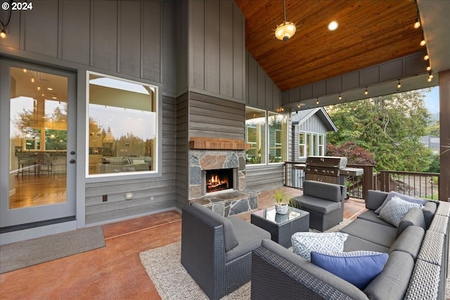 view of patio featuring a grill and an outdoor living space with a fireplace