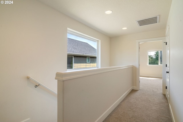 hallway with carpet flooring