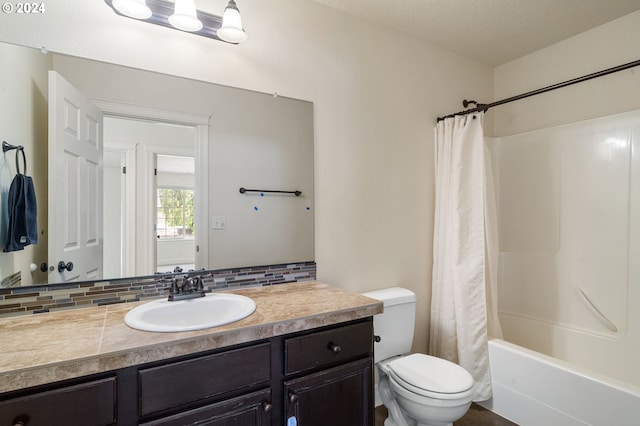 full bathroom with backsplash, vanity, shower / bath combo with shower curtain, a textured ceiling, and toilet